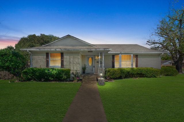 ranch-style home featuring a yard