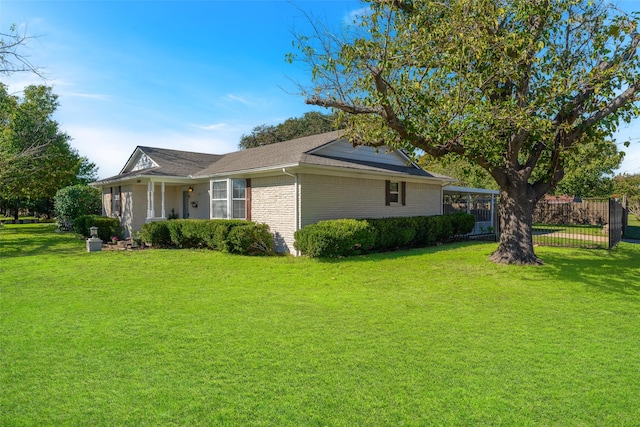 view of side of home with a yard