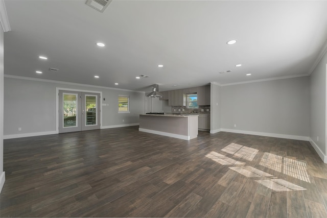 unfurnished living room with dark hardwood / wood-style floors and ornamental molding