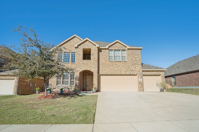 view of front of home featuring a front yard and a garage