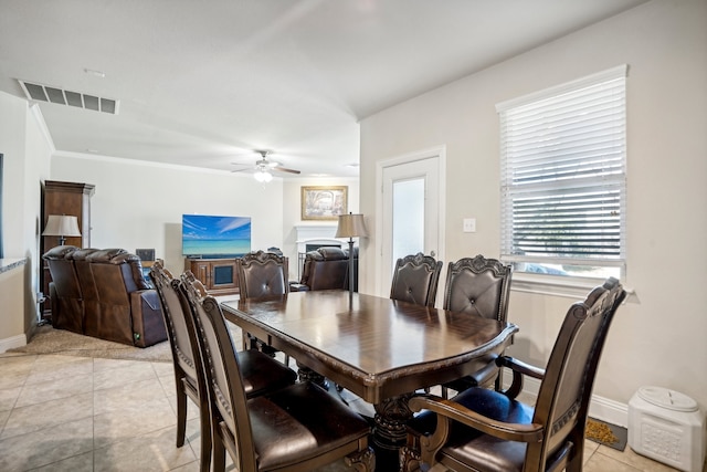 dining room featuring ceiling fan, light tile patterned floors, and ornamental molding