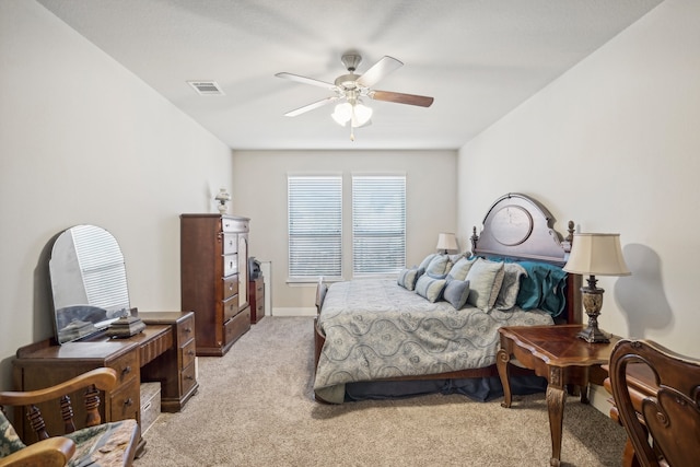 bedroom with ceiling fan and light carpet