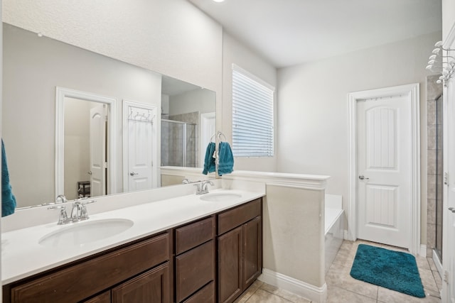 bathroom with tile patterned flooring, vanity, and shower with separate bathtub