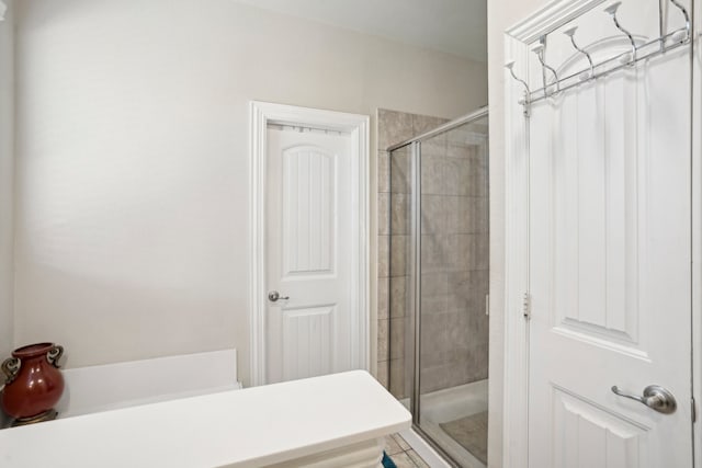 bathroom featuring tile patterned flooring and a shower with door