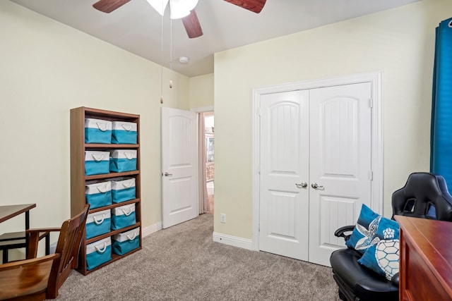 interior space featuring light carpet and ceiling fan