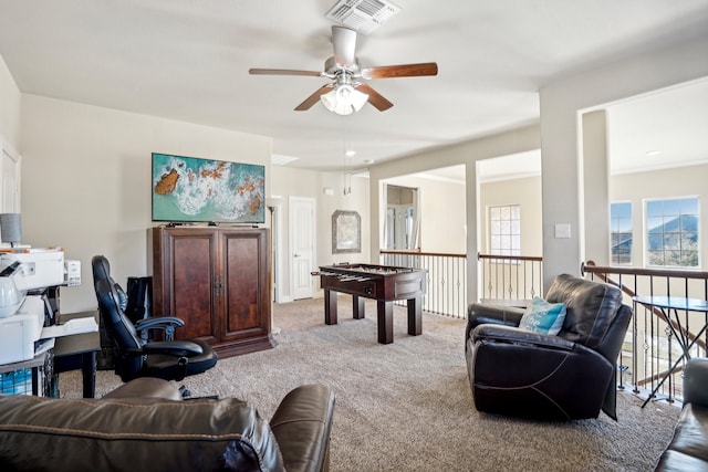 living room with ceiling fan and light colored carpet