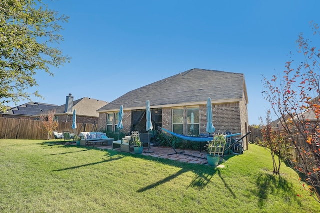 rear view of property featuring a lawn and an outdoor living space