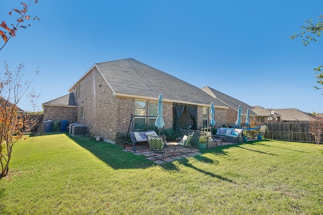 back of property with an outdoor living space, a yard, and central air condition unit