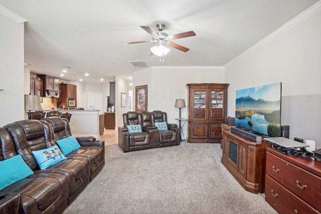 living room featuring ceiling fan, light colored carpet, and ornamental molding