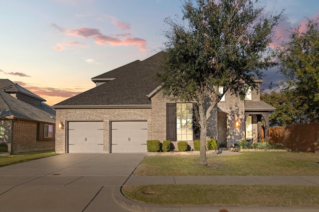 view of front facade featuring a lawn and a garage