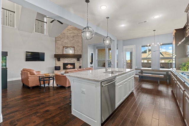 kitchen featuring a fireplace, a sink, visible vents, appliances with stainless steel finishes, and dark wood finished floors