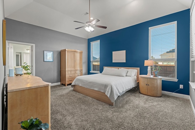 bedroom with ceiling fan, carpet floors, visible vents, baseboards, and vaulted ceiling