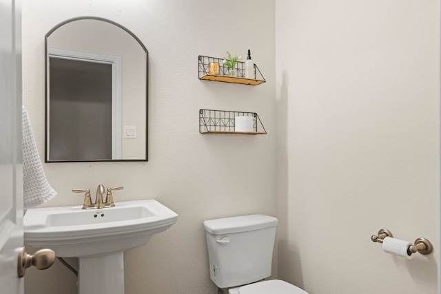 bathroom featuring toilet and a sink