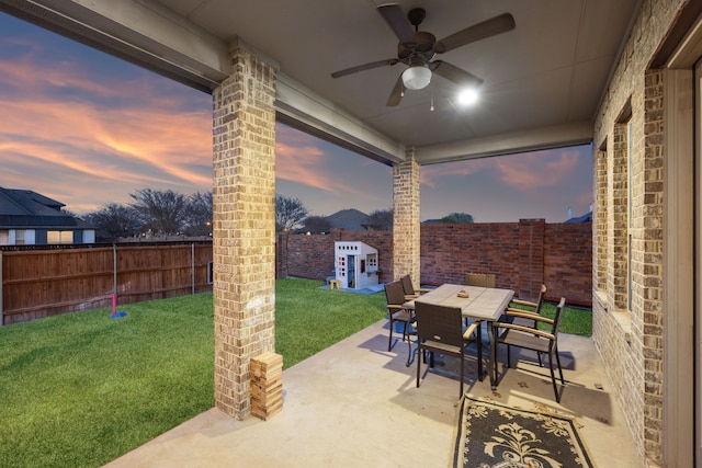 1100 Wedgewood Dr, Forney, TX 75126 - patio terrace at dusk featuring ceiling fan and outdoor dining space
