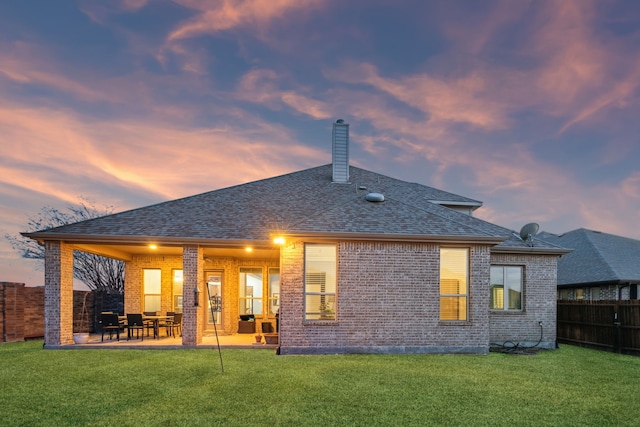 1100 Wedgewood Dr, Forney, TX 75126 - rear view of property featuring brick siding, a patio area, a shingled roof, and a chimney