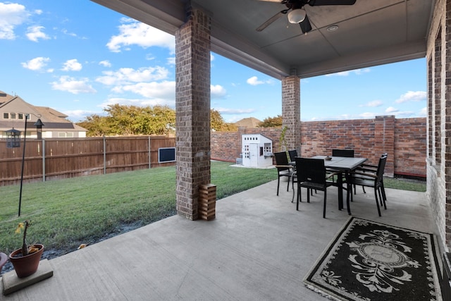 view of patio / terrace with ceiling fan and a storage shed