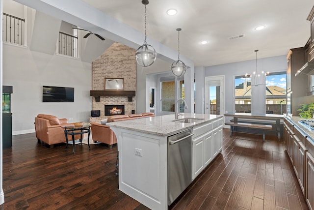 1100 Wedgewood Dr, Forney, TX 75126 - kitchen featuring a sink, a fireplace, stainless steel appliances, dark wood-style floors, and ceiling fan
