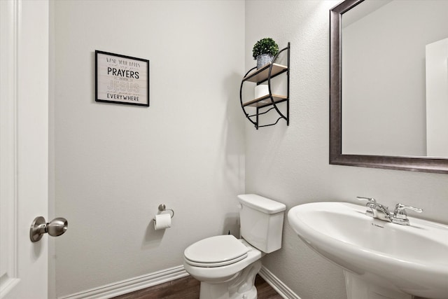 bathroom featuring sink, toilet, and hardwood / wood-style floors