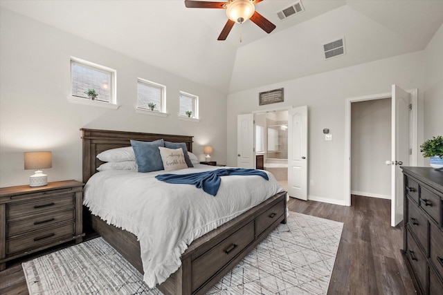 bedroom with ceiling fan, light hardwood / wood-style floors, connected bathroom, and lofted ceiling