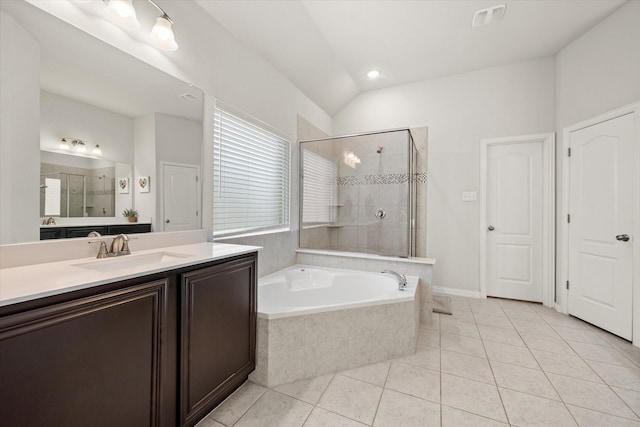 bathroom with tile patterned floors, vanity, plus walk in shower, and vaulted ceiling