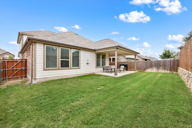 back of property with a patio and a yard