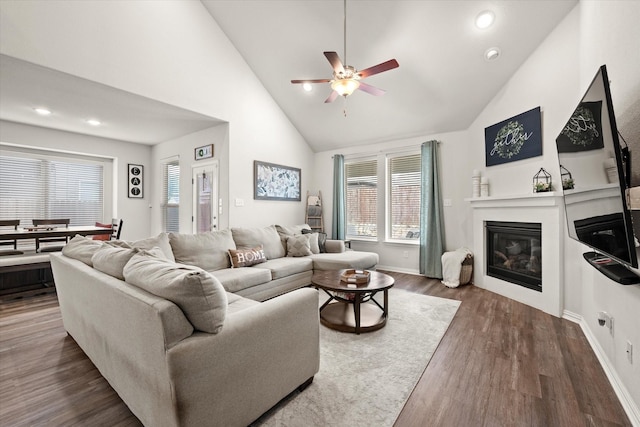 living room with ceiling fan, high vaulted ceiling, and dark hardwood / wood-style flooring