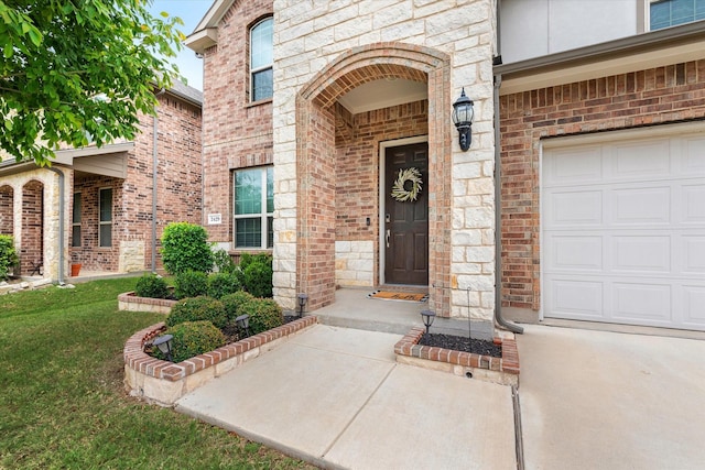 entrance to property with a yard and a garage