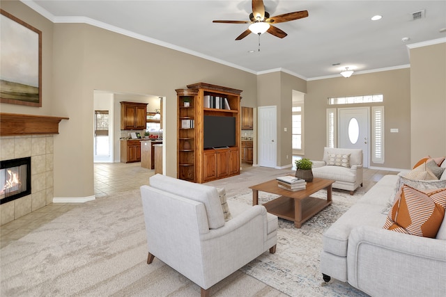 living room with ornamental molding, light carpet, and light tile patterned floors