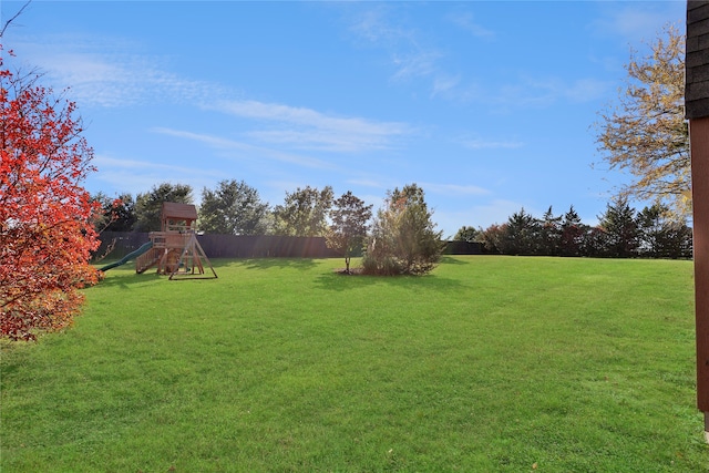 view of yard featuring a playground and fence