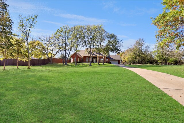 view of front of property featuring a lawn and a garage