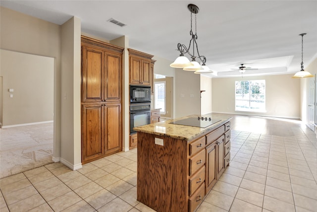 kitchen featuring a center island, decorative light fixtures, light tile patterned floors, and black appliances