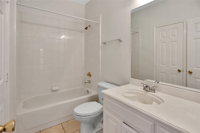 full bathroom featuring tile patterned flooring, vanity, tiled shower / bath combo, and toilet