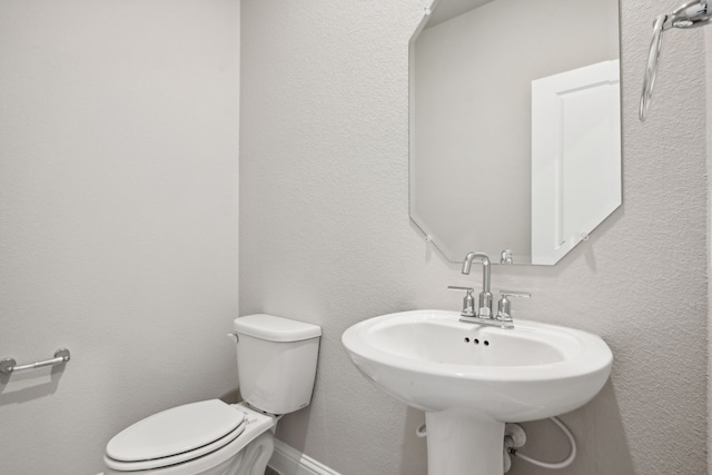 bathroom featuring sink and toilet