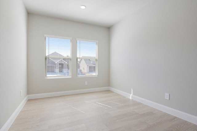 empty room with light hardwood / wood-style flooring