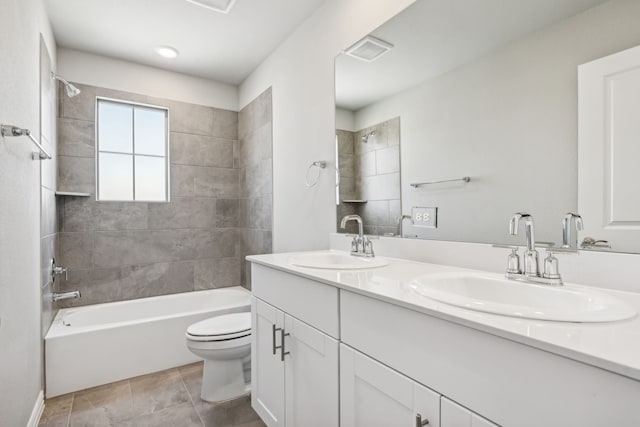 full bathroom with tile patterned floors, vanity, toilet, and tiled shower / bath