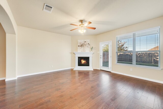 unfurnished living room featuring ceiling fan and wood-type flooring