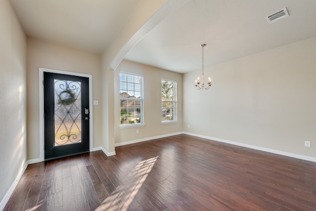 foyer featuring dark hardwood / wood-style flooring and an inviting chandelier