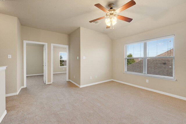 unfurnished room featuring ceiling fan, light carpet, and vaulted ceiling