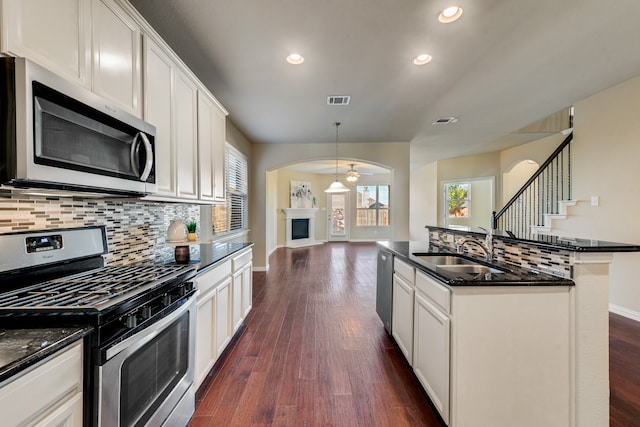 kitchen featuring stainless steel appliances, white cabinetry, ceiling fan, and sink