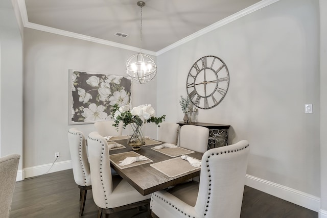 dining area with dark hardwood / wood-style flooring, ornamental molding, and an inviting chandelier