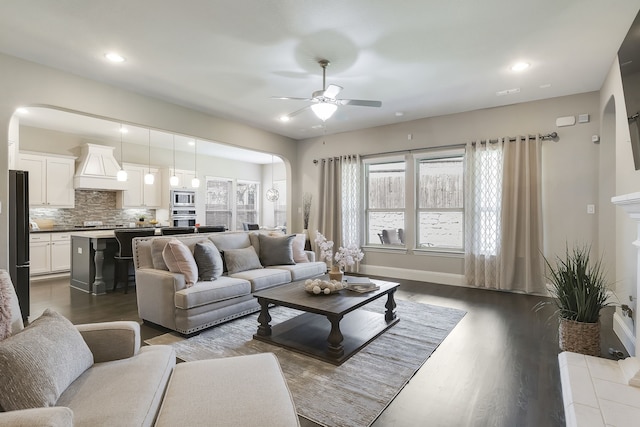 living room featuring ceiling fan and hardwood / wood-style flooring