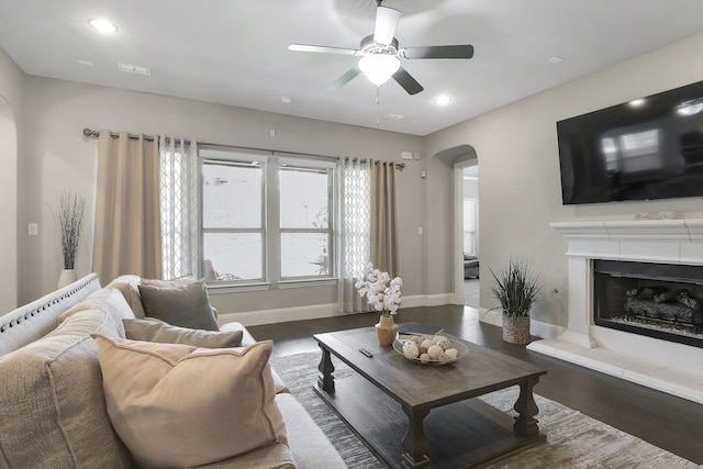 living room featuring dark hardwood / wood-style floors and ceiling fan