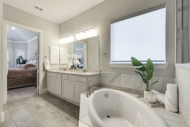 bathroom featuring vanity, a tub to relax in, and crown molding