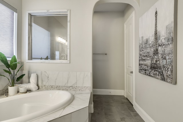 bathroom featuring tiled tub