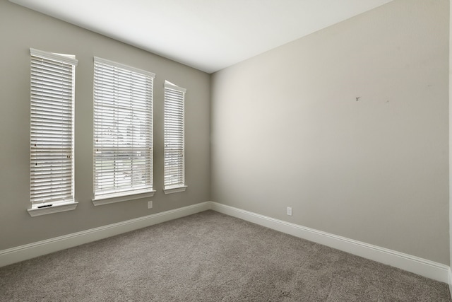 carpeted spare room with a healthy amount of sunlight