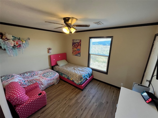 bedroom with ceiling fan, dark hardwood / wood-style flooring, and ornamental molding