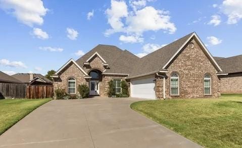 view of front of house with a garage and a front yard