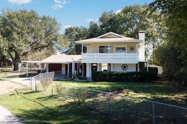 view of front of property featuring a carport, a balcony, and a front yard