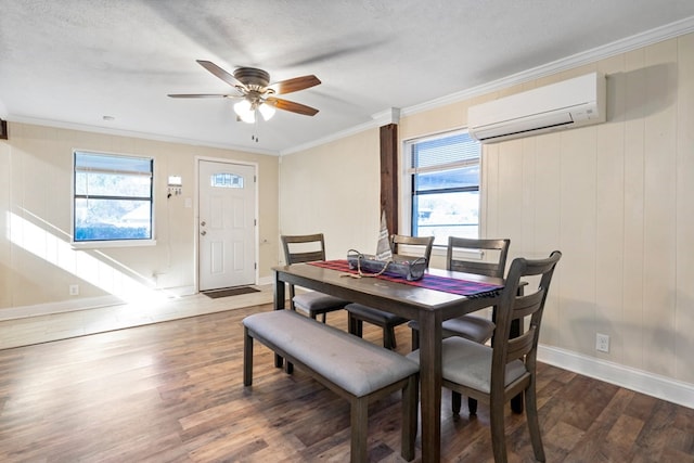 dining area with an AC wall unit, a wealth of natural light, ceiling fan, and dark wood-type flooring