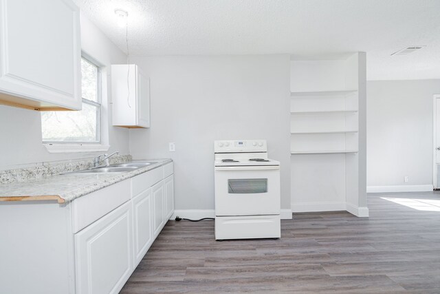 laundry area with hardwood / wood-style floors and a textured ceiling